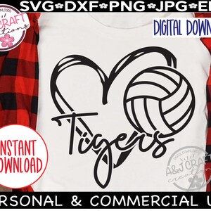 May include: A white t-shirt with a black graphic of a heart and volleyball, with the word "Tigers" in a script font. The shirt also has the words "Digital Download" and "Instant Download".