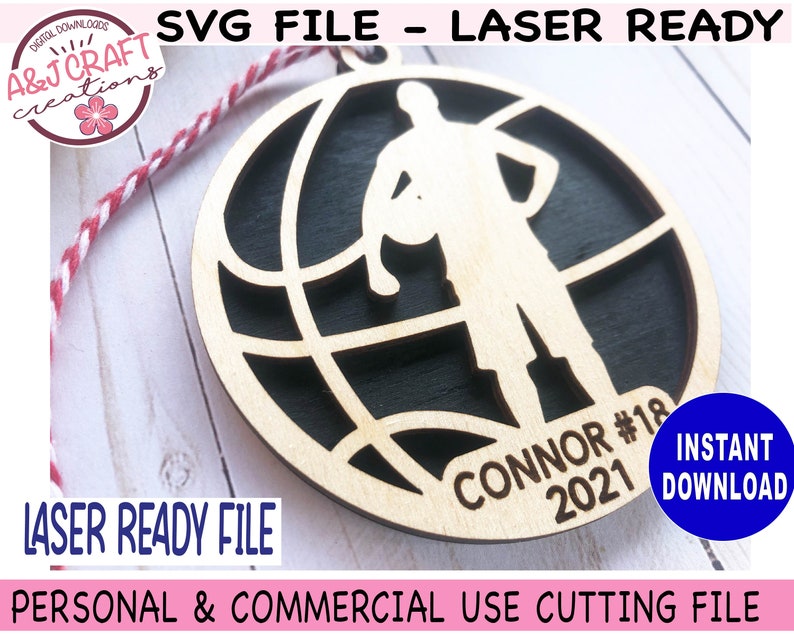 May include: A laser-cut wooden basketball ornament featuring a player silhouette holding a ball within a globe design. The ornament includes the name "CONNOR #18 2021". The design is laser-ready and available for instant download.