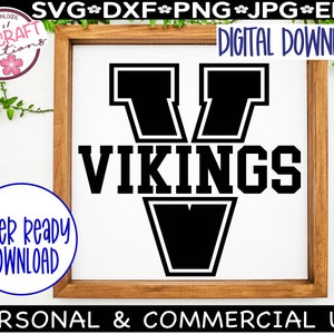 May include: A black and white graphic design of a large letter V with the word "VIKINGS" written below it. The letter V has a thick black outline and is in a bold, blocky font.