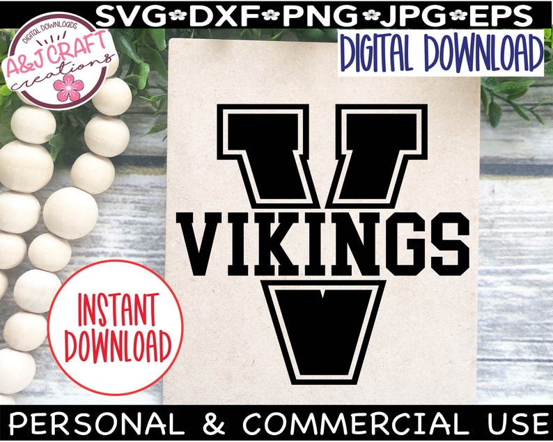 May include: Black and white digital download graphic of a stylized "V" with the word "VIKINGS" in bold letters below. The graphic is on a brown background.