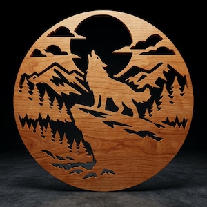 May include: A circular wooden wall art piece featuring a laser-cut silhouette of a wolf howling at a large moon. The design includes detailed cutouts of jagged mountain peaks, a dense forest of pine trees, and clouds against a dark background.