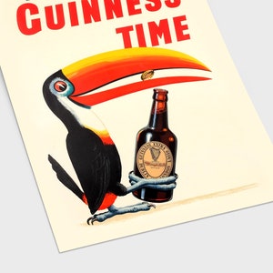 May include: A vintage advertisement for Guinness beer featuring a toucan holding a bottle of Guinness Extra Stout. The toucan has a red and yellow beak and black and white feathers. The text "GUINNESS TIME" is written in red letters at the top of the image.