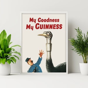 May include: Framed vintage poster with the text "My Goodness My Guinness" in red. The image features a cartoon ostrich wearing glasses, looking down at a man in a blue uniform holding a bottle. The poster is displayed on a white wall.