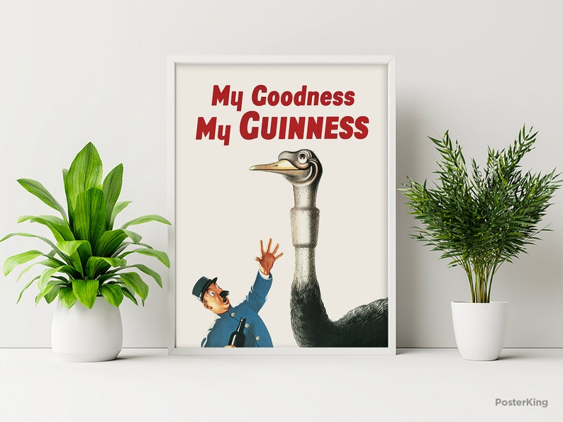 May include: Framed vintage poster with the text "My Goodness My Guinness" in red. The image features a cartoon ostrich wearing glasses, looking down at a man in a blue uniform holding a bottle. The poster is displayed on a white wall.