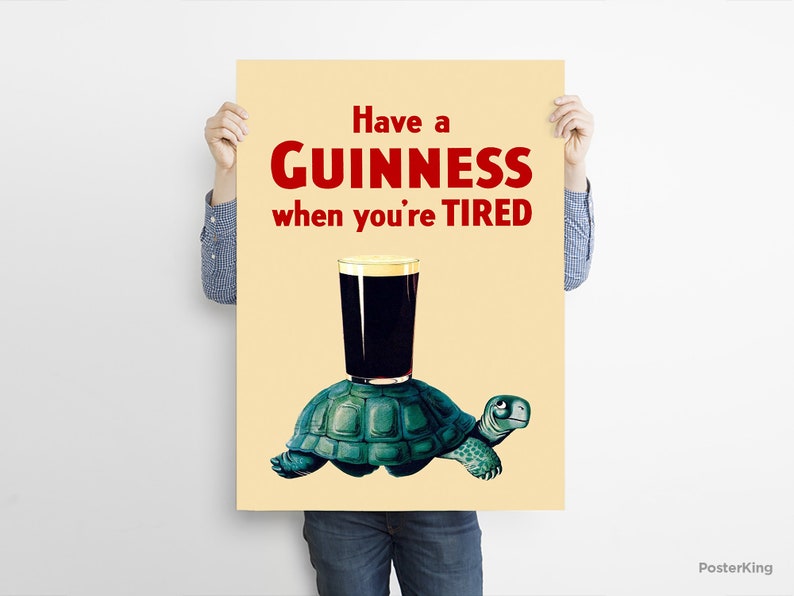 Pode incluir: Um p&ocirc;ster de estilo vintage que anuncia a cerveja Guinness com o texto "Have a GUINNESS when you're TIRED". O p&ocirc;ster apresenta uma ilustra&ccedil;&atilde;o de desenho animado de uma tartaruga carregando um copo de Guinness.