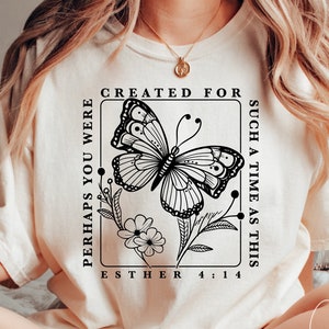 May include: A white t-shirt with a black butterfly graphic and the text "Perhaps you were created for such a time as this Esther 4:14".
