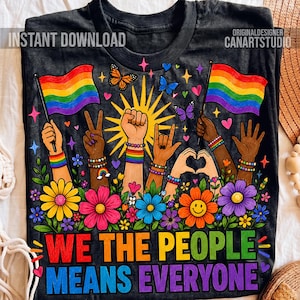 Könnte beinhalten: Ein schwarzes T-Shirt mit einer Grafik aus Regenbogenflaggen, erhobenen Fäusten und Händen, die ein Herz formen. Das Design enthält bunte Blumen, Schmetterlinge und den Text WE THE PEOPLE MEANS EVERYONE in fetten, mehrfarbigen Großbuchstaben.