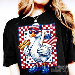 May include: Black t-shirt featuring a patriotic goose wearing sunglasses, a hat that says "AMERICA", and blue star-studded clogs. The goose holds a hot dog and an American flag. The background has a red, white, and blue star and checkered pattern.