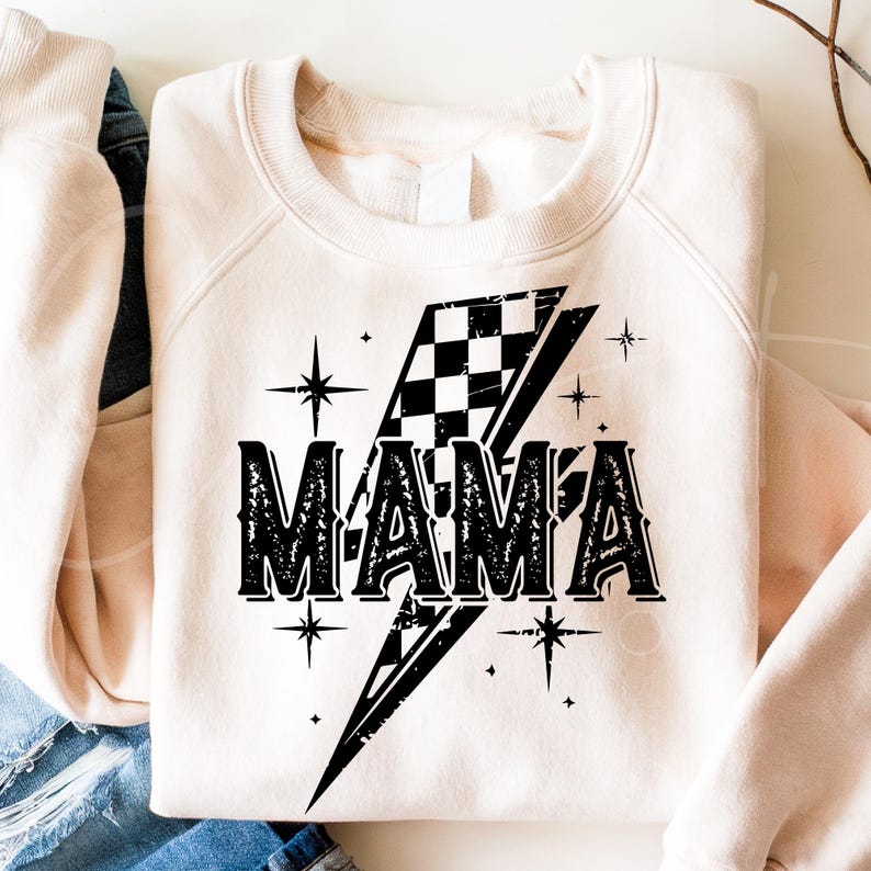 May include: A cream-colored sweatshirt with a black and white checkered lightning bolt design and the word "MAMA" in a distressed font.