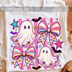 May include: A white t-shirt featuring a graphic print of two ghosts, two large bows with floral patterns, bats, and stars. The design includes vertical pink stripes and the text INSTANT DOWNLOAD and ORIGINALDESIGNER CANARTSTUDIO.