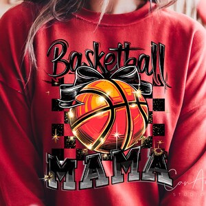 May include: Red sweatshirt featuring a basketball graphic and the text "Basketball Mama" in black and white.