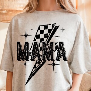 May include: Gray t-shirt with a black and white checkered lightning bolt design and the word "MAMA" in a vintage font.