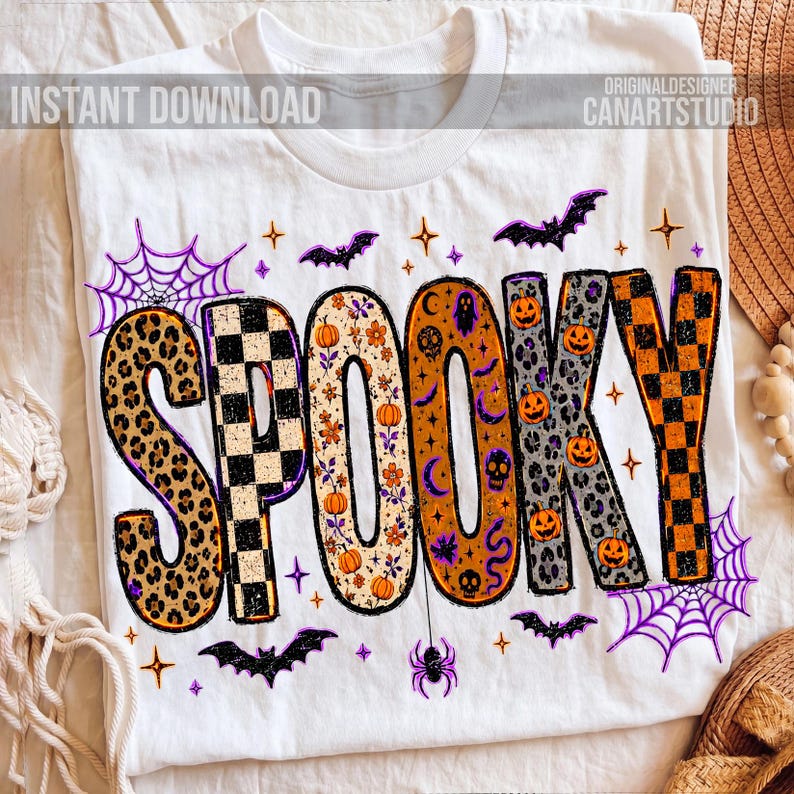 May include: White t-shirt with the word "SPOOKY" in large, colorful letters. The letters have various patterns, including leopard print, checkerboard, and floral designs. Halloween-themed graphics like bats, spiders, and pumpkins surround the word.
