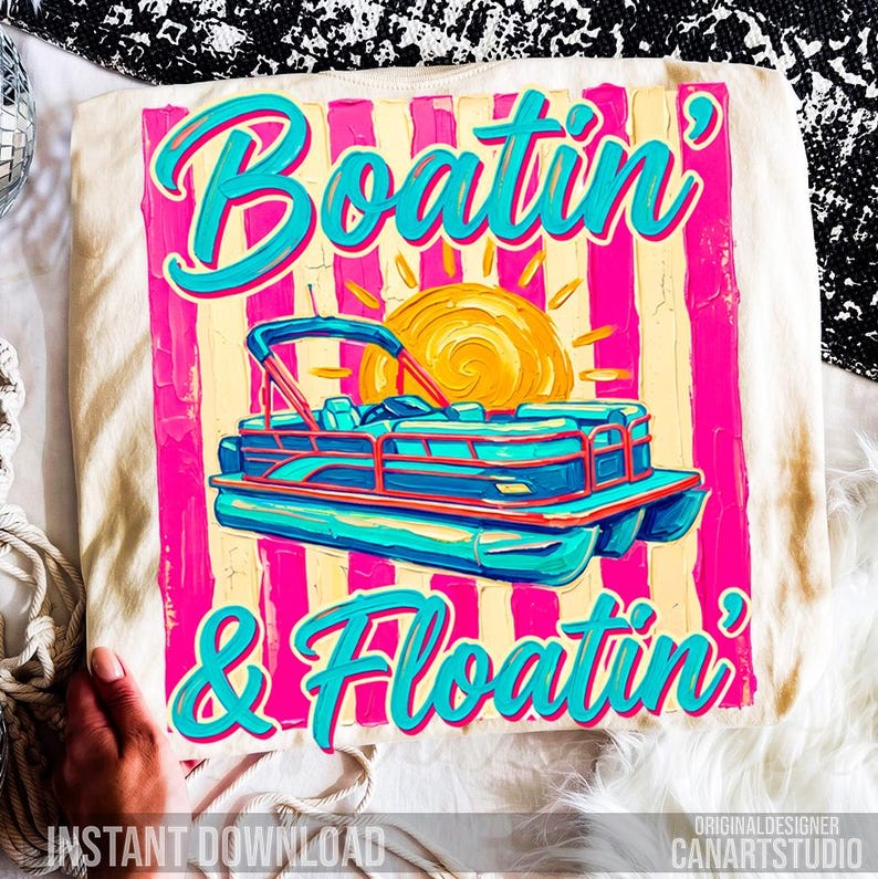 May include: Cream-colored t-shirt with a vibrant graphic. The design features a turquoise pontoon boat, a yellow sun, and the words "Boatin' & Floatin'" in turquoise script against a pink and yellow striped background. "Instant Download" is also visible.