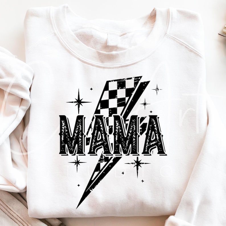 May include: White sweatshirt with a black and white checkered lightning bolt design and the word "MAMA" in a distressed font.
