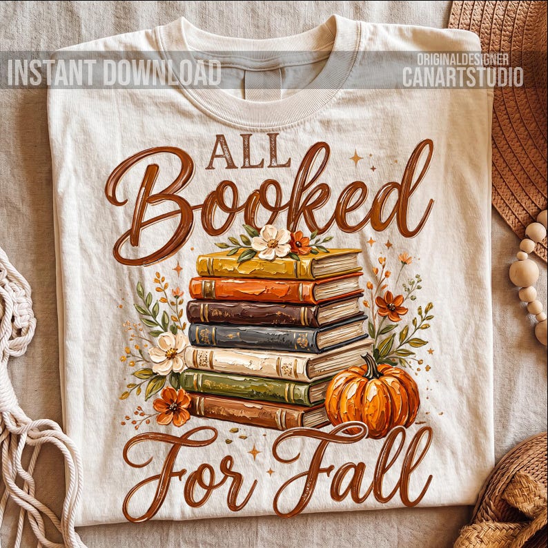 May include: Cream-colored t-shirt with the words "All Booked For Fall" in brown script. A stack of books in various colors, a pumpkin, and floral accents are featured in the design. The words "Instant Download" and "Original Designer CanArtStudio" are also visible.