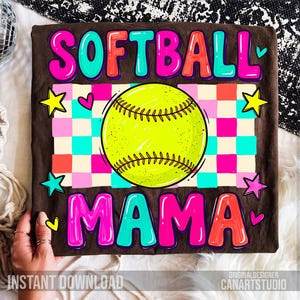 May include: A brown t-shirt with the words "SOFTBALL MAMA" in colorful bubble letters. A neon yellow softball is in the center, with a checkered background of pink, blue, and orange squares. The shirt also has star and heart graphics.