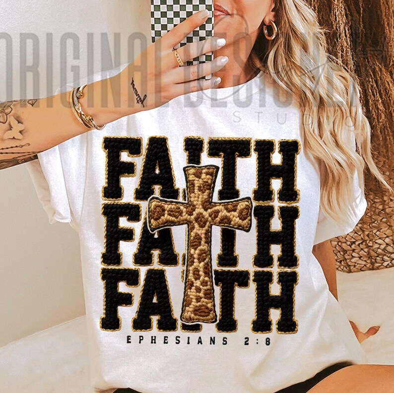 May include: White t-shirt with the word "FAITH" in black block letters, repeated three times, with a cross in the center. The cross has a leopard print design. The text "EPHESIANS 2:8" is printed at the bottom.
