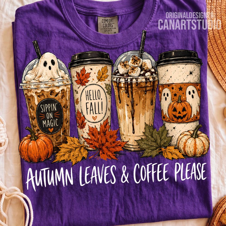 May include: A purple t-shirt featuring a graphic of four coffee cups with autumn themes, including a ghost, maple leaves, and pumpkins. The text reads Sippin on Magic, Hello, Fall!, and Autumn Leaves & Coffee Please. The shirt has a Comfort Colors label.