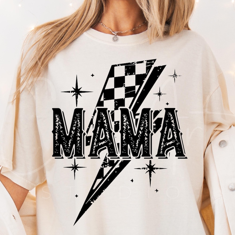 May include: White t-shirt with a black graphic of a checkered flag lightning bolt and the word "MAMA" in a vintage font.