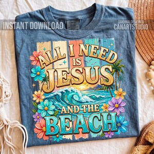 May include: Blue t-shirt with the text "ALL I NEED IS JESUS AND THE BEACH" in a colorful design. The design includes a beach scene with waves, palm trees, and flowers. The shirt also has the words "INSTANT DOWNLOAD" and "ORIGINALDESIGNER CANARTSTUDIO".