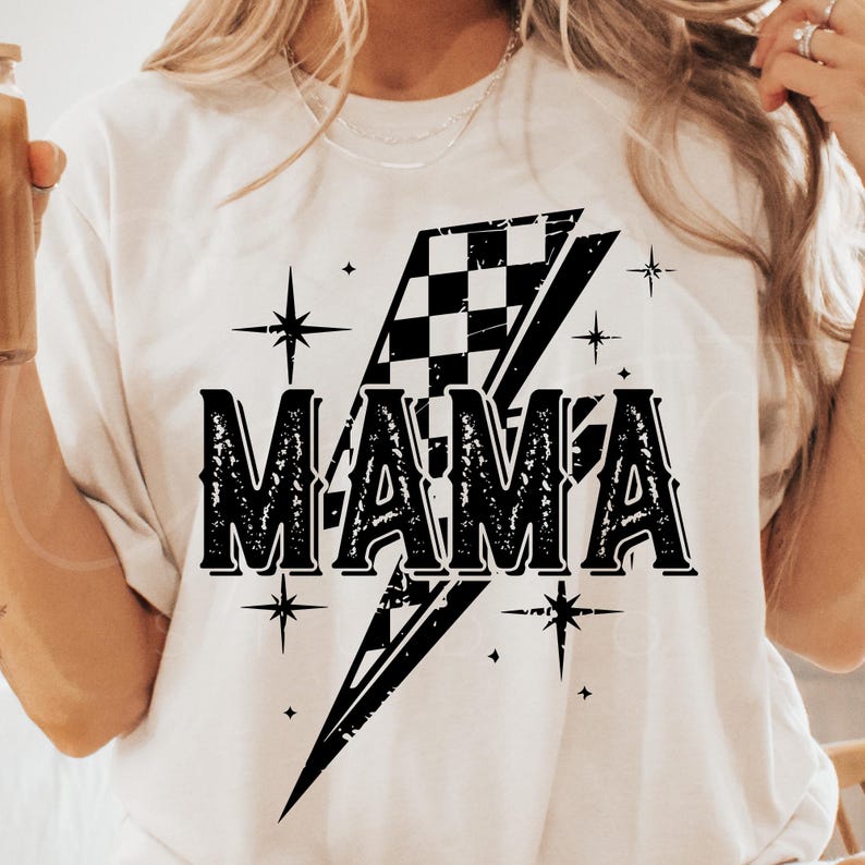 May include: White t-shirt with a black checkered lightning bolt graphic and the word "MAMA" in a vintage font.