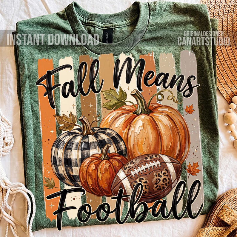 May include: Green t-shirt with a fall-themed graphic. The design features pumpkins, a football, and the text "Fall Means Football" in black script. The shirt has a vintage, distressed look.