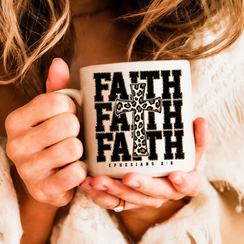 May include: White ceramic mug with a black and white graphic of the word "FAITH" repeated three times with a leopard print cross in the center. The text "EPHESIANS 2:8" is printed below the graphic.