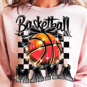May include: Pink sweatshirt with a black and white graphic design of a basketball with the text "Basketball Mama".