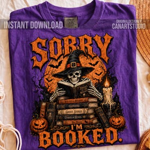 May include: A purple t-shirt featuring a graphic of a skeleton wearing a witch hat and reading a book titled Tales of the Night. The design includes stacks of books, pumpkins, a candle, and the text Sorry I'm Booked in orange lettering.