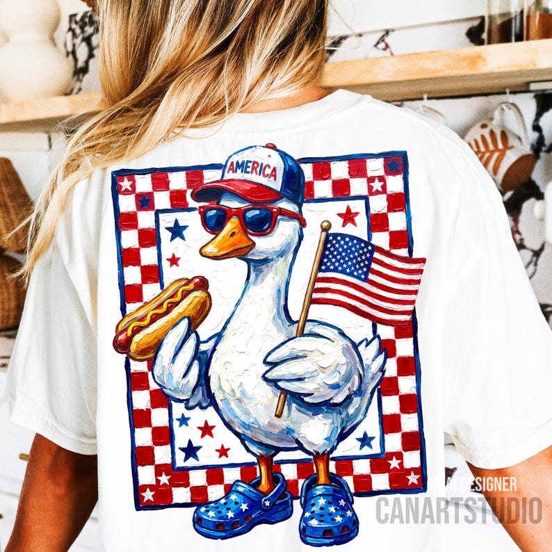May include: White t-shirt featuring a cartoon goose wearing sunglasses, a baseball cap with "AMERICA" on it, and blue clogs. The goose holds a hot dog and an American flag. The design includes red, white, and blue stars and a checkered border.