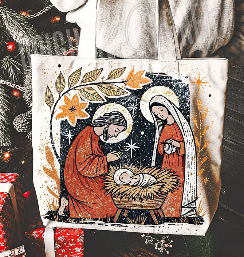 May include: Off-white tote bag featuring a nativity scene illustration. The design includes figures in orange robes, a baby in a manger, and floral accents. The artwork has a vintage, distressed style, with a starry night background.