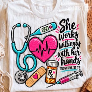 May include: A white t-shirt featuring a graphic design with a teal stethoscope, a pink heart with an EKG line, a digital thermometer reading 98.6, a tan adhesive bandage with a pink heart, a pill bottle, and a syringe with the text She works willingly with her hands PROVERBS 31:13.