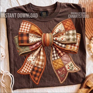 May include: Brown t-shirt with a large, patchwork bow design. The bow features various patterns, including gingham and floral prints, in shades of orange, brown, and cream. The text "INSTANT DOWNLOAD" is on the left and "CANARTSTUDIO" on the right.