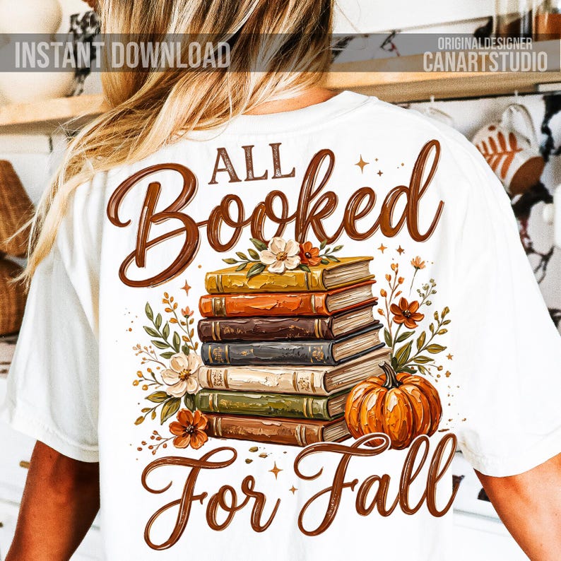 May include: White t-shirt with a fall-themed graphic. The design features a stack of books, a pumpkin, and floral accents. Text reads "All Booked For Fall" in brown script. "Instant Download" and "CanArtStudio" are also visible.