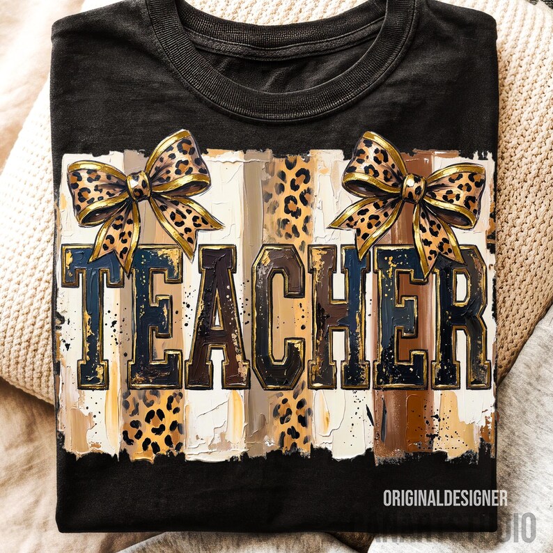 May include: Black t-shirt with the word "TEACHER" in a bold, textured font. The design includes leopard print bows and vertical stripes in shades of brown, beige, and blue. The words "ORIGINALDESIGNER" are at the bottom.