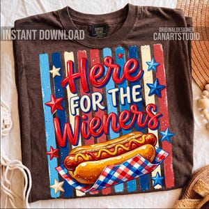 May include: Brown t-shirt with a graphic that says "Here for the Wieners." The design features a hot dog, red, white, and blue stripes, and stars. The shirt has a vintage look.