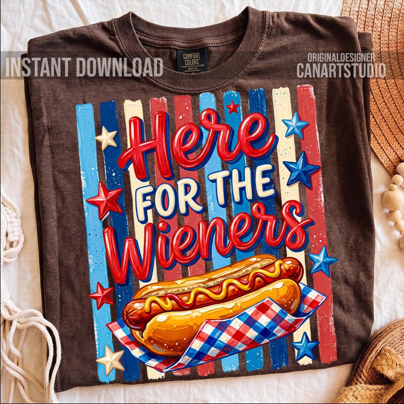 May include: Brown t-shirt with a graphic that says "Here for the Wieners." The design features a hot dog, red, white, and blue stripes, and stars. The shirt has a vintage look.