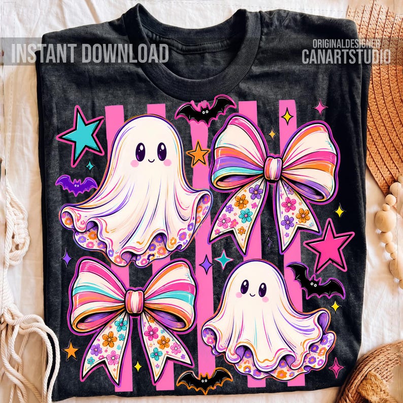 May include: A black t-shirt featuring a graphic print of two white ghosts, two large colorful bows with floral patterns, several small bats, and pink stars. The text INSTANT DOWNLOAD and CANARTSTUDIO is printed in the upper corners of the shirt.