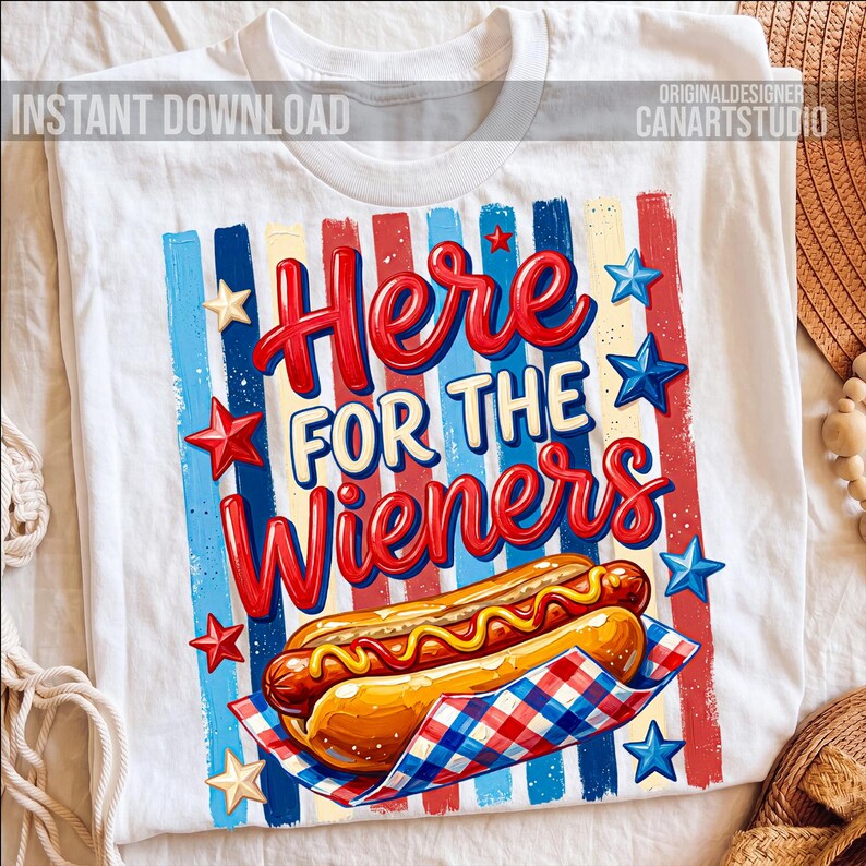 May include: White t-shirt with a graphic design featuring the text "Here for the Wieners" in red and blue. The design includes a hot dog, stars, and vertical stripes in red, white, and blue.