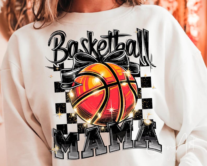 May include: White sweatshirt with a black and orange basketball graphic and the text "Basketball Mama".