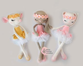 May include: Three handmade crochet ballerina dolls. Each doll is a different animal: a mouse, a bunny, and a cat. They wear tutus, flower crowns, and ballet slippers. The dolls are in shades of white, pink, yellow, and tan.