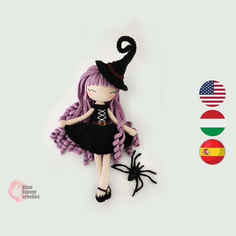 May include: Crocheted witch doll with purple hair, a black dress, and a black witch hat. The doll is lying on its back with its legs spread out. A black crocheted spider is next to the doll.
