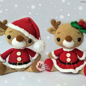 May include: Two crocheted reindeer wearing Santa Claus outfits. One reindeer is wearing a red hat with a white pom-pom and the other reindeer is wearing a green holly wreath with red berries.