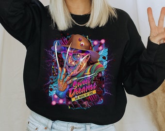 May include: Black sweatshirt with a colorful graphic of a horror movie character wearing a hat and sunglasses. The graphic includes the text "Sweet Dreams Are Made Of This".