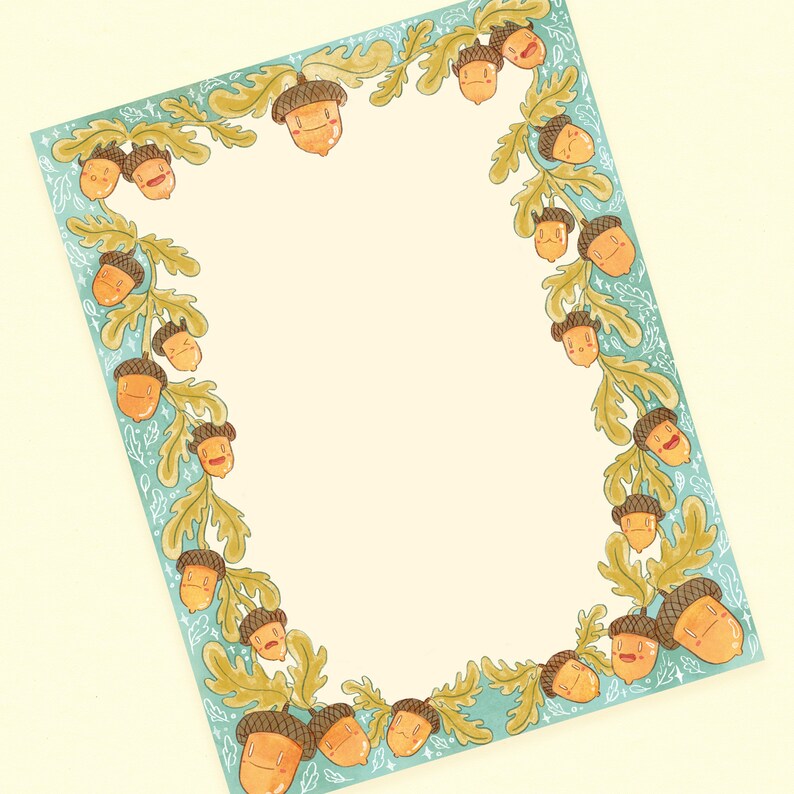 May include: A rectangular piece of stationery with a light yellow center, framed by a teal border with a repeating pattern of acorns and oak leaves. The acorns have smiling faces and are colored in shades of orange and brown.