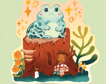 Könnte beinhalten: Eine skurrile Illustration zeigt einen hellblauen Frosch mit dunklen Flecken auf einem Baumstumpf. Die Szene umfasst eine Eichelfigur, Pilze, Blumen und eine kleine geisterhafte Figur, alles vor einem weichen grünen Hintergrund mit funkelnden Akzenten.