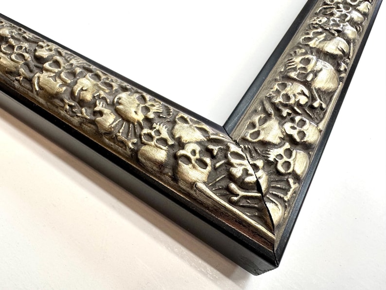 May include: Close-up of a black picture frame with a silver ornate design featuring skulls and other decorative elements. Skulls Gothic Picture Frames Silver Black Eclectic Unique Photo Display Metallic Wood  Gift Wall Deco 4x6 5x7 8x10 11x14 16x20 18x24