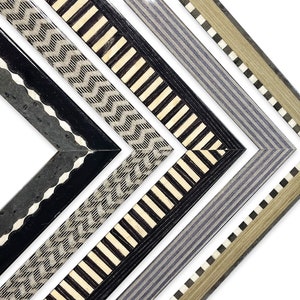 May include: Four different picture frames with black, white, and gray geometric patterns. The frames are made of wood and have a beveled edge.
