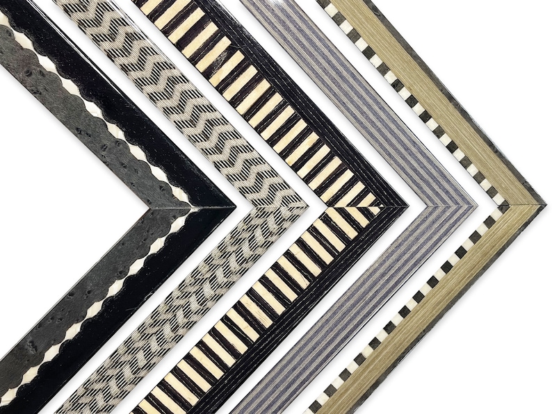 May include: Four different picture frames with black, white, and gray geometric patterns. The frames are made of wood and have a beveled edge.